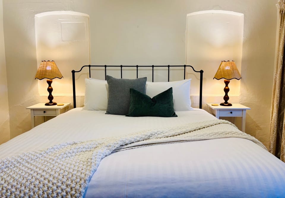 Image of the master bedroom (one king size bed) in the Flaxman cottage.