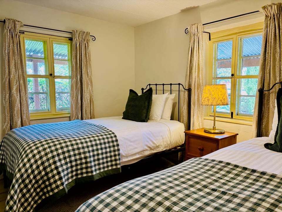 Image from one side of the second bedroom (two king single beds) in the Flaxman cottage.