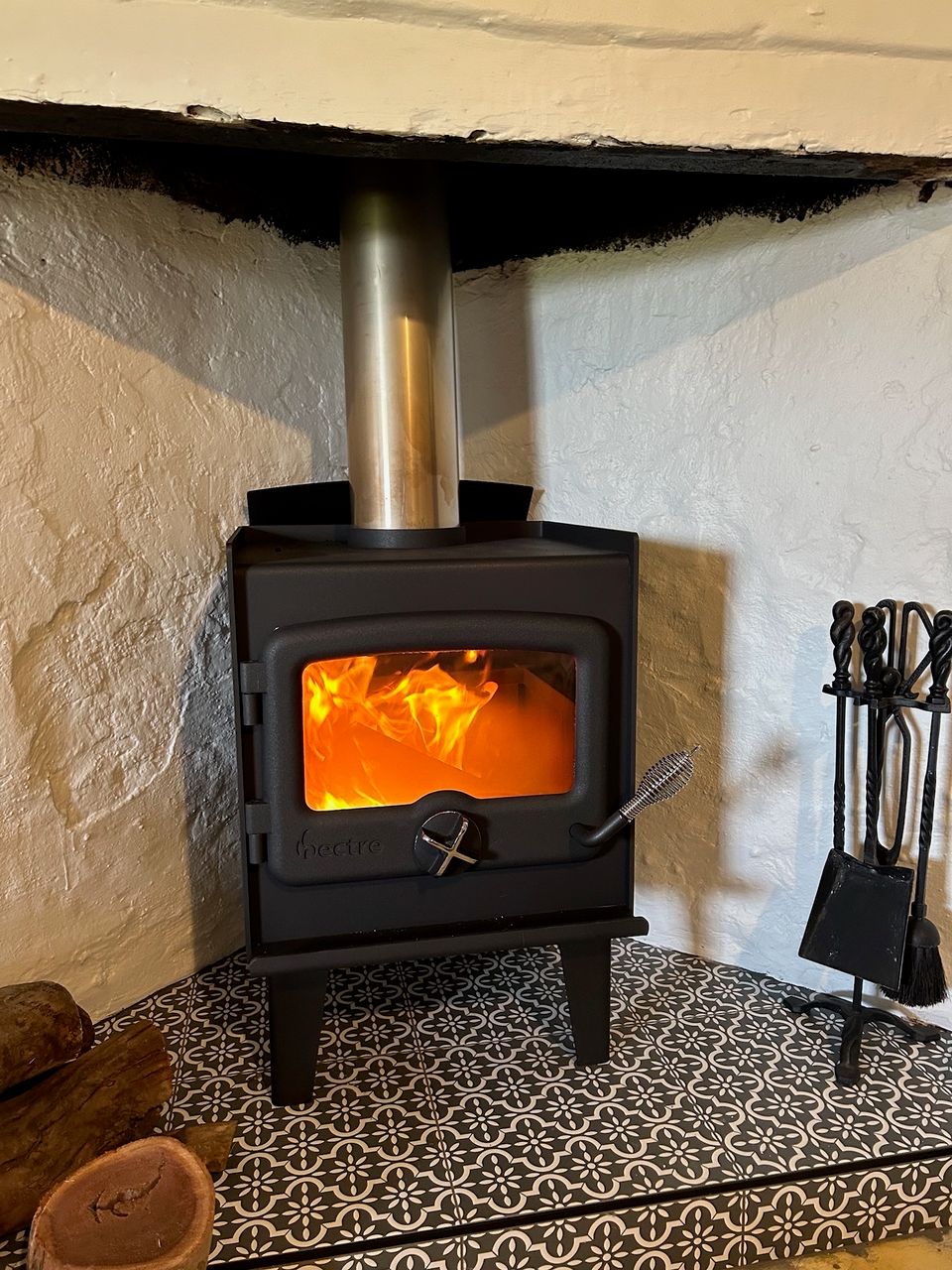 Image of the cosy fireplace in the living room of the Flaxman cottage.